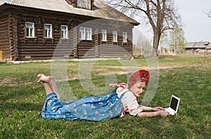 Girl in national dress with a computer