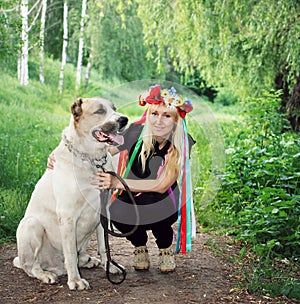 Girl in national wreath next big dog