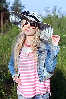 Girl on the nature in a hat