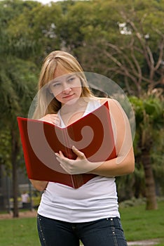 Girl on nature with a writing-book