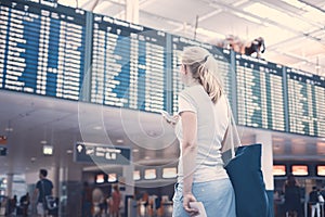 Girl near airline schedule