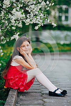 Girl near apple tree flowers in the park