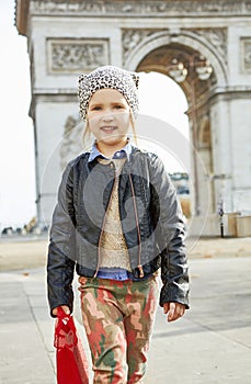 Girl near Arc de Triomphe in Paris, France going forward