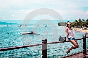 Girl near boat in Beautiful Island Ilhabela Brazil Brasil