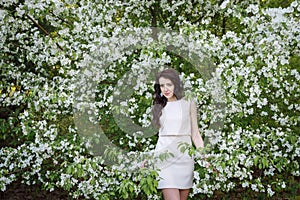 Girl near a bush of white flowers