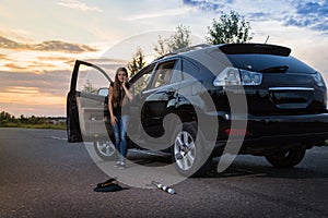 Girl near the car looking with horror at the cap and baton of a police officer. Female driver hiting a COP. Russia