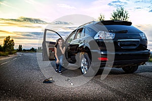 Girl near the car looking with horror at the cap and baton of a police officer. Female driver hiting a COP. Russia