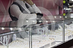 Girl near a counter salesman in a jewelry store