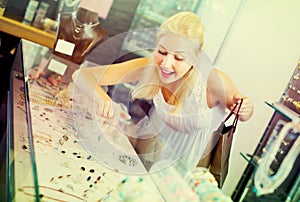 Girl near glass showcase in bijouterie store