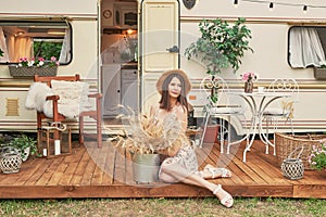 Girl near house on wheels on picnic. Family vacation travel RV,holiday trip in motorhome.Caravan car Vacation. Caravan car,