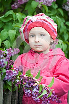 Girl near lilac bush in the garden