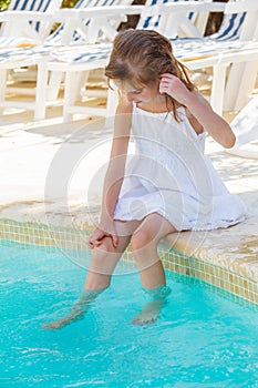 Girl near outdoor swimming pool