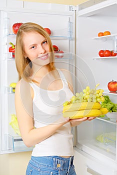 Girl near the refrigerator