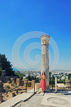 Girl near the ruins of Carthage. Column on the hill Byrsa at the Roman marble column, near the Punic port photo