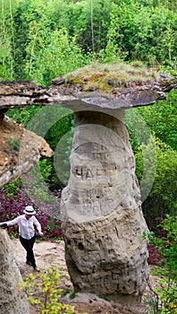 Girl neatly is faring the bottom attractions Yakutia - errozitsionnoy forms terrain sandy mushroom in the forest