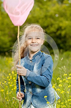 Girl with a net catching butterflies