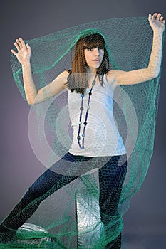 girl in netting posing on tyres