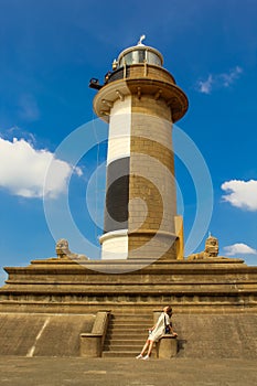 The girl next to the lighthouse in Colombo, Sri Lanka