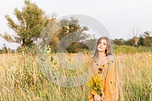 Girl with nosegay in field