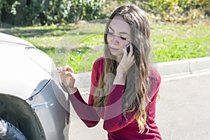 Girl notices fresh scratches on the bumper photo