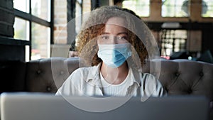 Girl observes modern precautions and wears medical mask rest in a cafe