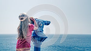 Girl observing via telescope