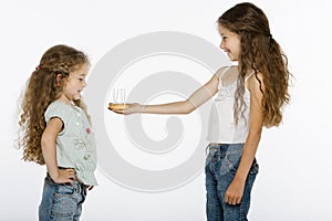 Girl offering bithday cake