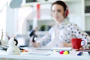 Girl in the office with markers and calculator. A photograph with a depth of sharpness, a highlighted focus on the