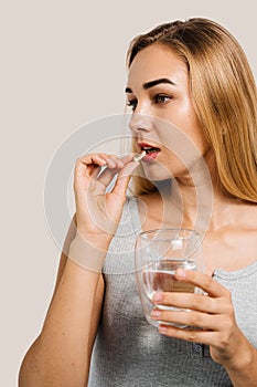 Girl with Omega 3 capsule of fish fat oil in hands close-up. BADS pills of biologically active dietary supplements