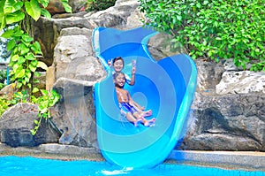 A girl ond a boy a slide