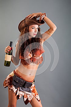 Girl in Open Cowboy Dance Costume Hat Poses with Bottle