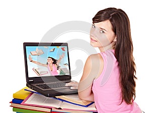 Girl with open laptop and book.