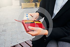 Girl with an open wallet. Money and credit cards in woman hands