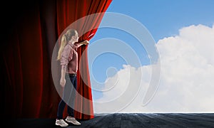 Girl opening curtain