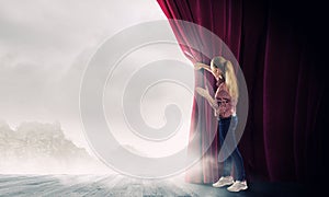 Girl opening curtain