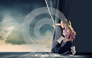 Girl opening curtain