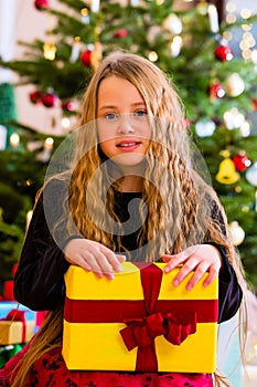 Girl opening present on Christmas day