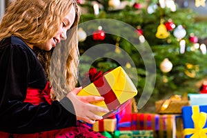 Girl opening present on Christmas day