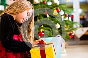 Girl opening present on Christmas day