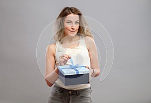 Girl opening a present isolated