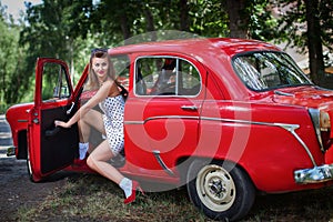 The girl opens the door of the car