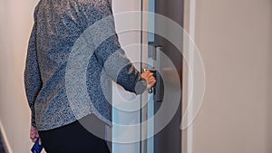 Girl opens door to room with an electronic key. Secure key card system in the hotel. Vacation at the hotel. Safe lock