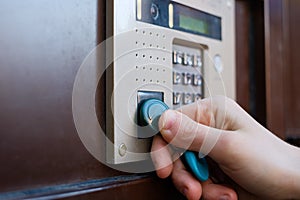 The girl opens the front door with a magnetic tablet.