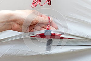 The girl opens a ventilation window in a tourist tent and fixes it with a velcro.