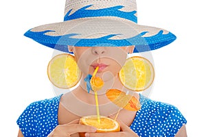 Girl with Orange Drink and Orange Slice Earrings Wearing Hat White Background