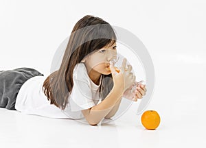 Girl with orange and glass of juice