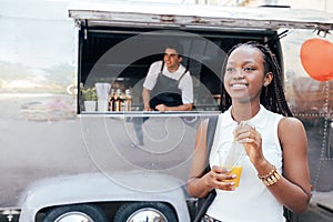 Girl with orange juice that she bought in a food truck