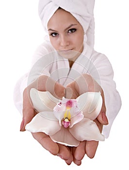 Girl with orchid and white towel on head .