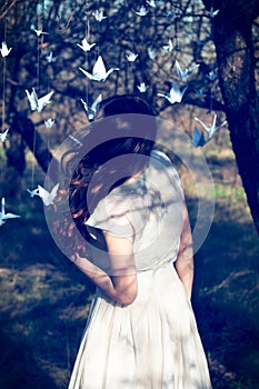 Girl with origami cranes