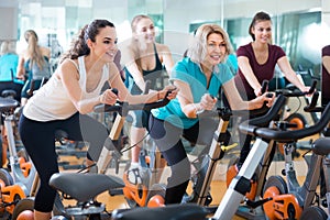 Girl and other females working out in sport club